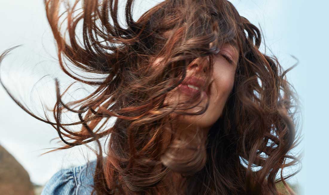 Smiling woman with light and repaired hair